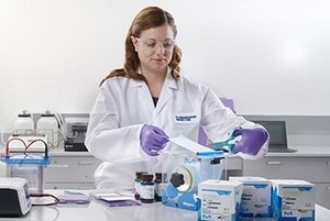 This image depicts a scientist performing an experiment.