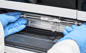 Changing of an HPLC Column Lab worker handling an HPLC column.
