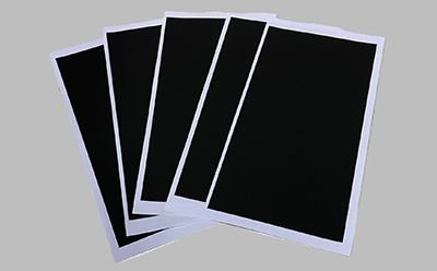 A set of five black electrode sheets arranged in a fan shape against a gray background. Each sheet has a white border, highlighting their rectangular shape and uniform thickness. A set of five black electrode sheets arranged in a fan shape against a gray background. Each sheet has a white border, highlighting their rectangular shape and uniform thickness.