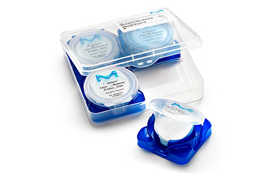 A transparent plastic container featuring Millipore Durapore membrane filters. The container has a blue base and is opened to display three small round filter containers with white lids and labels, one of which is partially open, revealing its filter. A transparent plastic container featuring Millipore Durapore membrane filters. The container has a blue base and is opened to display three small round filter containers with white lids and labels, one of which is partially open, revealing its filter.