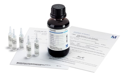 The image displays a dark bottle with a white label and black cap, alongside several clear ampoules containing liquid, and an information leaflet, all arranged on a white surface.