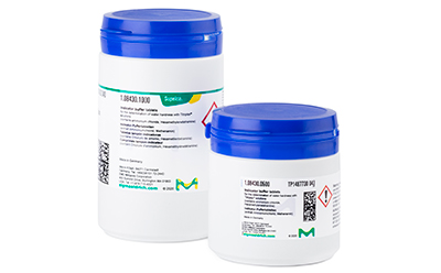 Two white plastic containers with blue lids and labeled with green and blue text, standing against a white background. Two white plastic containers with blue lids and labeled with green and blue text, standing against a white background.