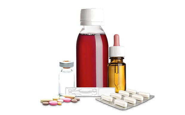 Formulation An assortment of medical items, including a bottle of red liquid medicine with a white cap, a small glass vial with a metal cap, a dropper bottle with amber-colored liquid, and various pills and capsules, some loose and some in blister packs.
