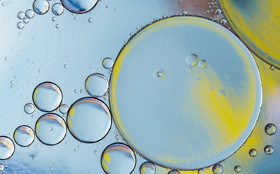 Detergents and Surfactants Microscopic view of detergent or surfactant droplets suspended in liquid, illustrating emulsions used in laboratory and research applications.