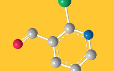 Halogenated Heterocycles A 3D molecular structure illustration on a yellow background. The model shows a ring structure with gray spheres representing carbon atoms, connected by white bonds. Various colored spheres represent different atoms: a red sphere (possibly oxygen), a green sphere, and a blue sphere. The arrangement highlights the molecular connectivity and geometry.