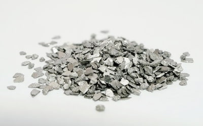 A close-up view of tungsten metal pieces, showcasing their dense and shiny surfaces.