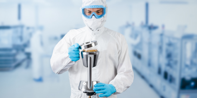 <p>Get your Aseptic Facility Ready for EU GMP Annex 1</p>
Person in full cleanroom clothing and blue gloves holds a microbial air sampler in an aseptic manufacturing facility.