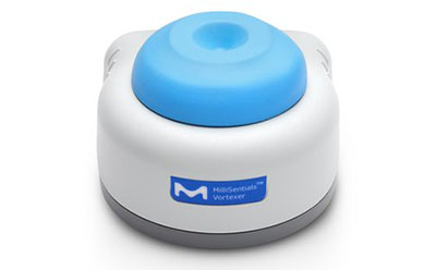 A compact, white and blue, electronic vortex mixer with the ‘M’ logo and ‘HausserScientific Vortexer’ written on the front, placed against a plain white background.
