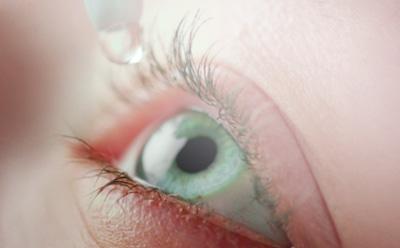 Close-up of eye with eye drops being put inside
