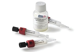 Biotinylated protein purification The image features a small white bottle with medication and three HiTrap Protein G HP syringes used for protein purification. The syringes have a white body, red caps, and black plungers. The bottle and syringes have labels with dosage instructions.