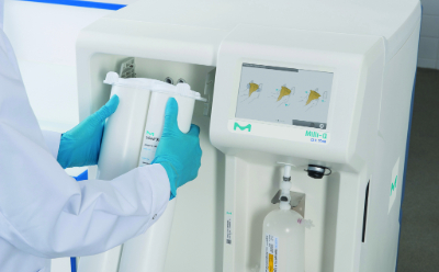 Arms of a scientist in a white lab coat and blue-gloved hands changing a purification cartridge of a water system