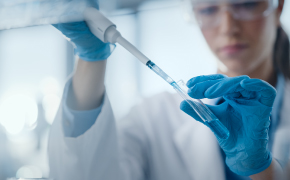 Lead optimization Automated liquid handling system with multiple pipette tips dispensing samples into a microplate for high-throughput biochemical screening.