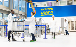 Downstream Processing (DSP) for mAbs Four scientists stand working in different corners of a lab
