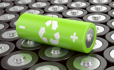 Green lithium‑ion battery symbolizing sustainable energy materials. Green lithium ion battery with a circular arrows icon over a background of metallic batteries, indicating sustainable battery practices.