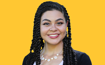 Sydney Floranzia Sydney Floranzia headshot on a vibrant yellow background