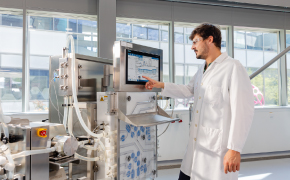 Streamline computer system validation (CSV) A process engineer interacting with a digital control screen on downstream processing equipment.