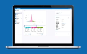 Millicell Cloud Digital Screenshot A laptop displaying a data analysis interface on a blue background. The screen shows a colorful graph with a prominent peak in pink, along with data tables below it highlighted in green, blue, and pink. On the left side, there are navigation options, and on the right side, there is a panel with detailed information about the analysis.