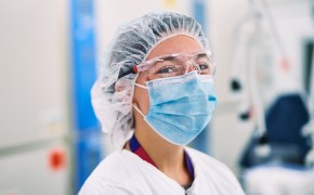 BioReliance® Cell Therapy Testing Services Scientist in full PPE working in contract testing lab