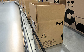 Cardboard boxes on a production line meeting zero deforestation standards. Cardboard boxes on a production line meeting zero deforestation standards.