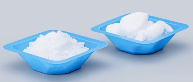 emsure-granulated-salts-vs-caked-salts Side-by-side comparison of free-flowing EMSURE® granulated salt and conventional powdered salt showing larger granules and a caked powder form in separate blue trays.