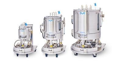 Three Mobius Single-Use Bioreactors (10 L, 100 L, 500 L) aligned next to each other. Each bioreactor consists of a cylindrical vessel with multiple ports and tubes attached, mounted on a wheeled support structure for mobility.