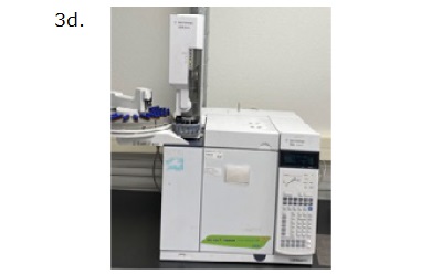 GC-FID instrument A laboratory gas chromatograph (GC) machine, specifically an Agilent Technologies 7890B model. The machine is primarily white with a digital control panel featuring a keypad and a small screen on the right side. To the left of the control panel, there is a cylindrical injection unit where samples are introduced into the machine. The top left part of the machine includes an auto-sampler with multiple blue-capped vials arranged in a circular tray. The image is labeled "3d." in the top left corner. The GC machine is placed on a lab bench against a white wall.