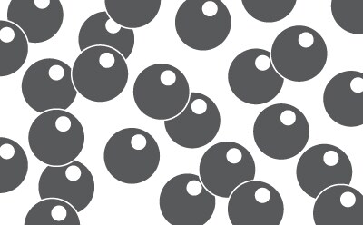 Close-up view of synthetic activated carbon particles, showcasing their spherical shape and dark coloration against a white background.