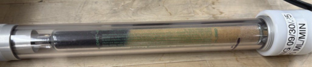 OMI® purifier tube showing sorbent color change Transparent OMI® gas purifier tube with visible color change along the sorbent bed, indicating contaminant adsorption during operation.