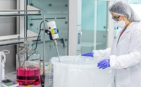 A photo showing a scientist and custom cell culture media