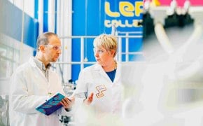 A photo showing two process scientists discussing and taking notes on a notebook in a M Lab™ Collaboration Center.