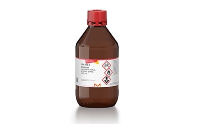 The image is of a a brown plastic bottle with a red cap and a white label, which contains Methanol.