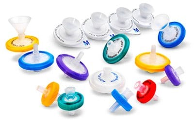 Sterile and Nonsterile Millex® Syringe Filters An assortment of Millex<sup>®</sup> syringe filters in various colors and sizes, displayed against a white background. These filters represent a range of small-volume filtration options for laboratory use. The filters come in different colors such as blue, green, yellow, purple, and red, indicating different filter types or pore sizes. Each filter has a circular shape with a conical funnel-like structure on top for attaching to a syringe. The central part of the filters is white with labeling that includes the brand name “Millex®”. Some filters have a transparent top section while others are opaque. There is also one funnel accessory included in the image which is used to assist with pouring liquids into the filter. These filters set the standard in small-volume filtration (1-200 mL), and their unsurpassed consistency in sample preparation has led to the development of many methods specifying their use.