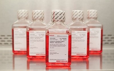 DMEM The image features a series of five identical square-shaped bottles containing a red liquid, “Tetramethylrhodamine Ethylene Diamine,” each capped with a white and black zigzag pattern.