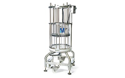 Stainless steel circular chromatography column mounted on a stand. It has multiple vertical tubes connected by metal rings at the top and bottom. Adjustment knobs and levers are present on the stand below the column. The equipment is mounted on a metal stand with caster wheels for mobility.