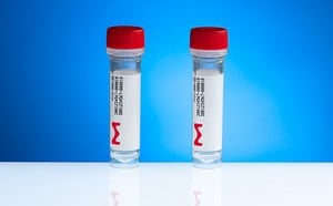 Two laboratory sample vials with red caps