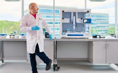 Scientist walking away from the bench Scientist walking away from the bench, turning back to look at the AAW™ workstation