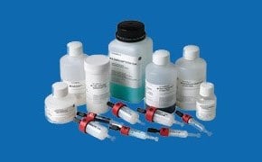 An assortment of Cytiva™ laboratory products used for drug discovery research and therapeutics bioprocess manufacturing. The products are arranged on a blue background and include Whatman<sup>®</sup> lab filtration bottles, Amersham™ chromatography columns and resins, and other reagents.