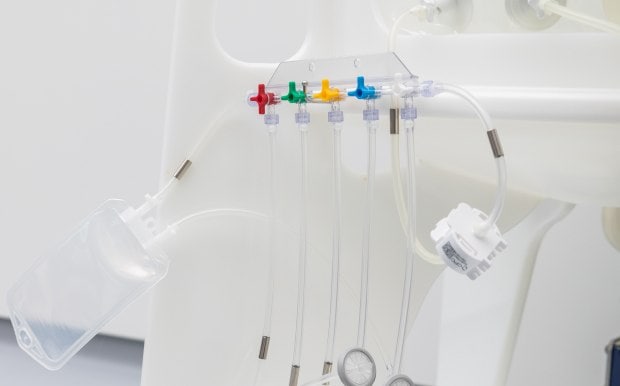 A transparent, plastic NovaSeptum® SURe sampling assembly connected with tubing to a single-use biopharmaceutical process.