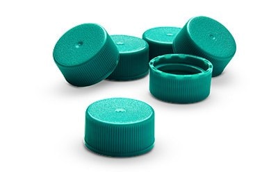 Turquoise caps scattered on a white background.