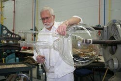 Photo of glassblower repairing large glass reaction vessel