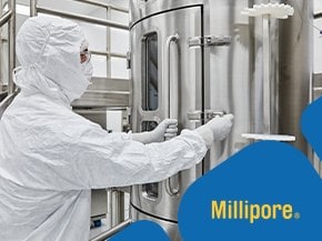 A person in a full protective suit and mask operating a large stainless steel piece of equipment in a cleanroom environment. The image features a blue and yellow design element with the Millipore® logo in the corner.