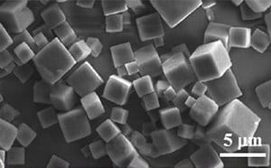 SEM image showing densely packed cubic PODS® crystals with a 5 µm scale bar.