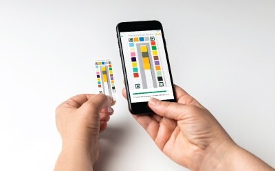 A user reads the chemical parameter test result by scanning the dipped MQuant® Test Strip using the MQuant® StripScan App on a smart phone