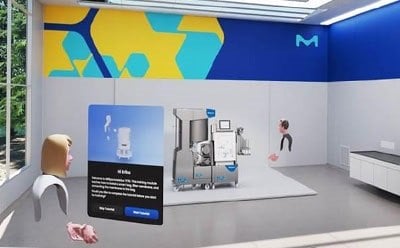 A virtual reality training room featuring a modern laboratory setup with a prominent piece of equipment in the center. On the left, a digital avatar represents a user interacting with the environment. A floating information panel displays details about the equipment, while the walls are decorated with abstract patterns in blue and yellow, showcasing the M logo.