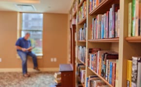 Bookshelves filled with books in a reading room, symbolizing guidance and learning resources related to energy and water efficiency.